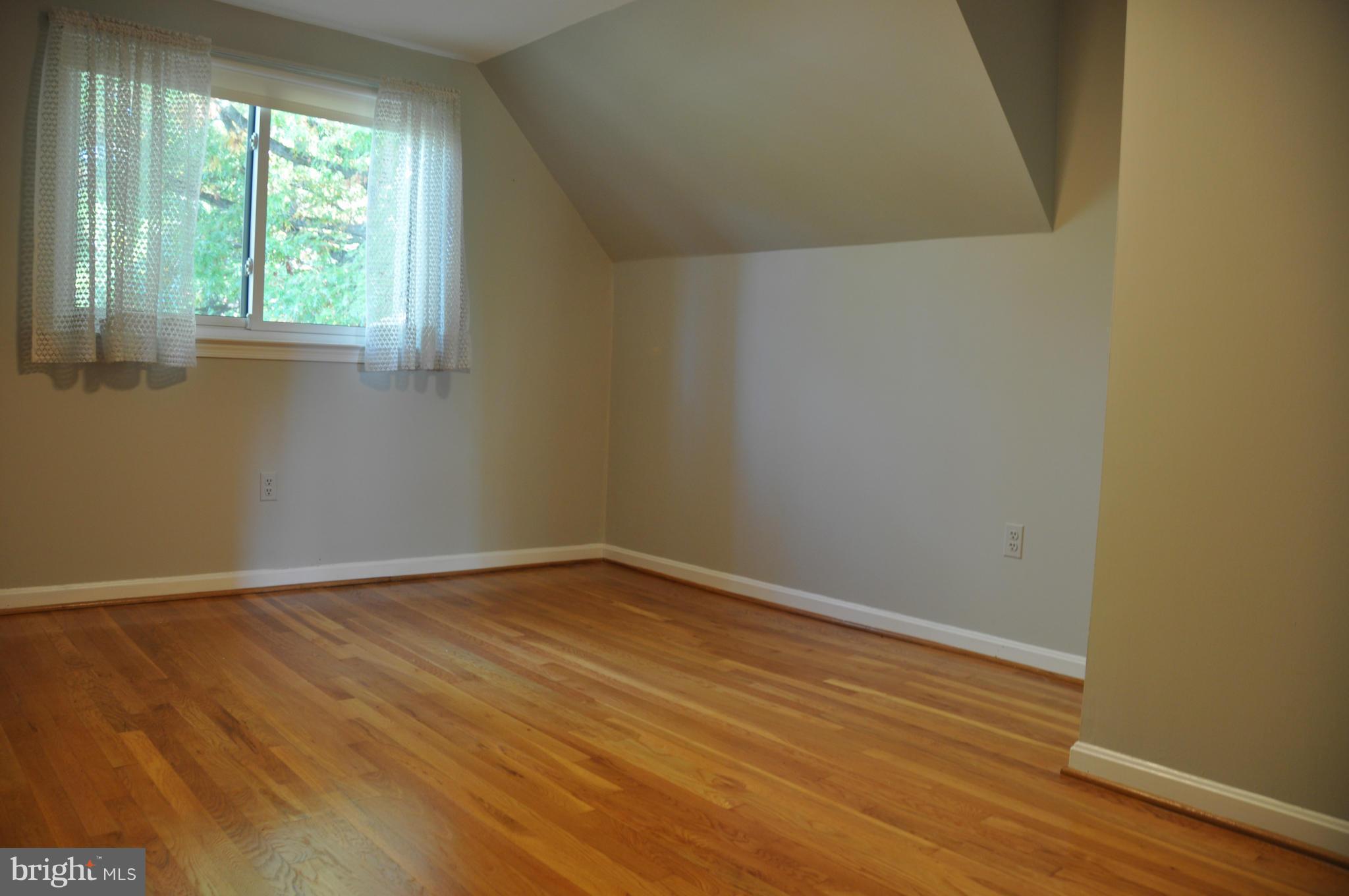 5417 Rolling Road Springfield, VA 22151 - Photo 11 of 20 an empty room with wooden floor and windows