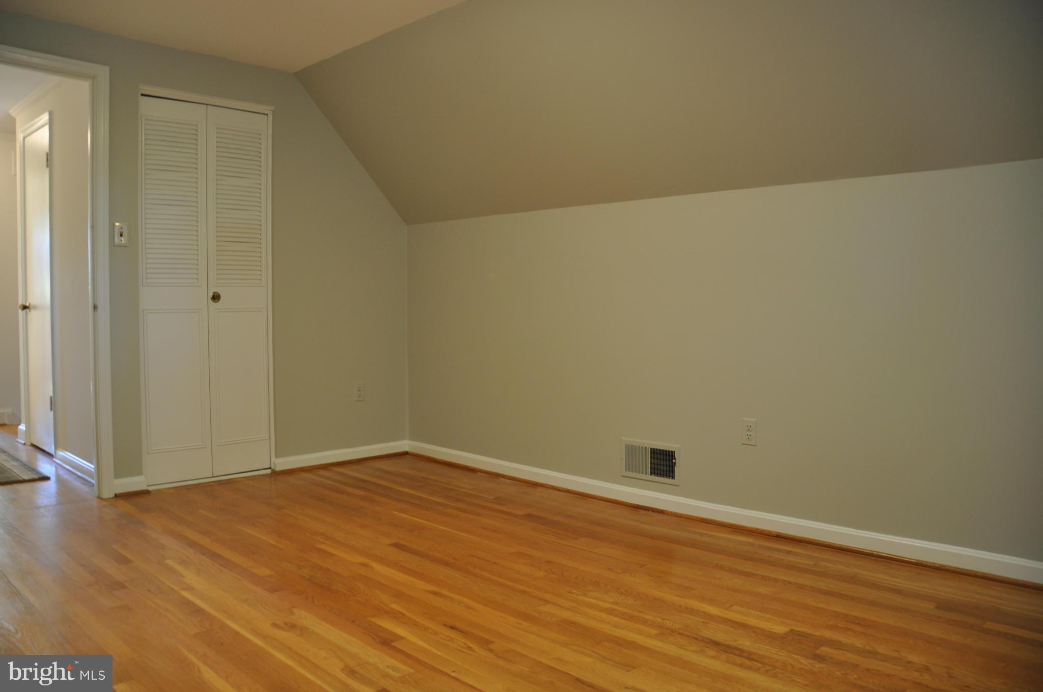 5417 Rolling Road Springfield, VA 22151 - Photo 12 of 20 an empty room with wooden floor and windows