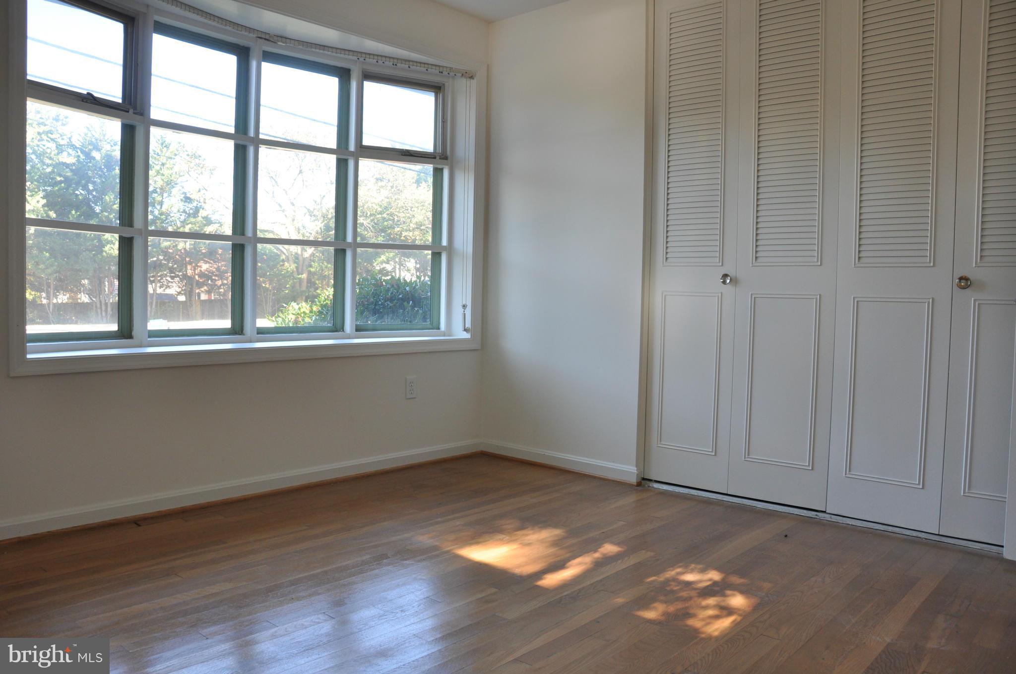 5417 Rolling Road Springfield, VA 22151 - Photo 15 of 20 an empty room with wooden floor and windows