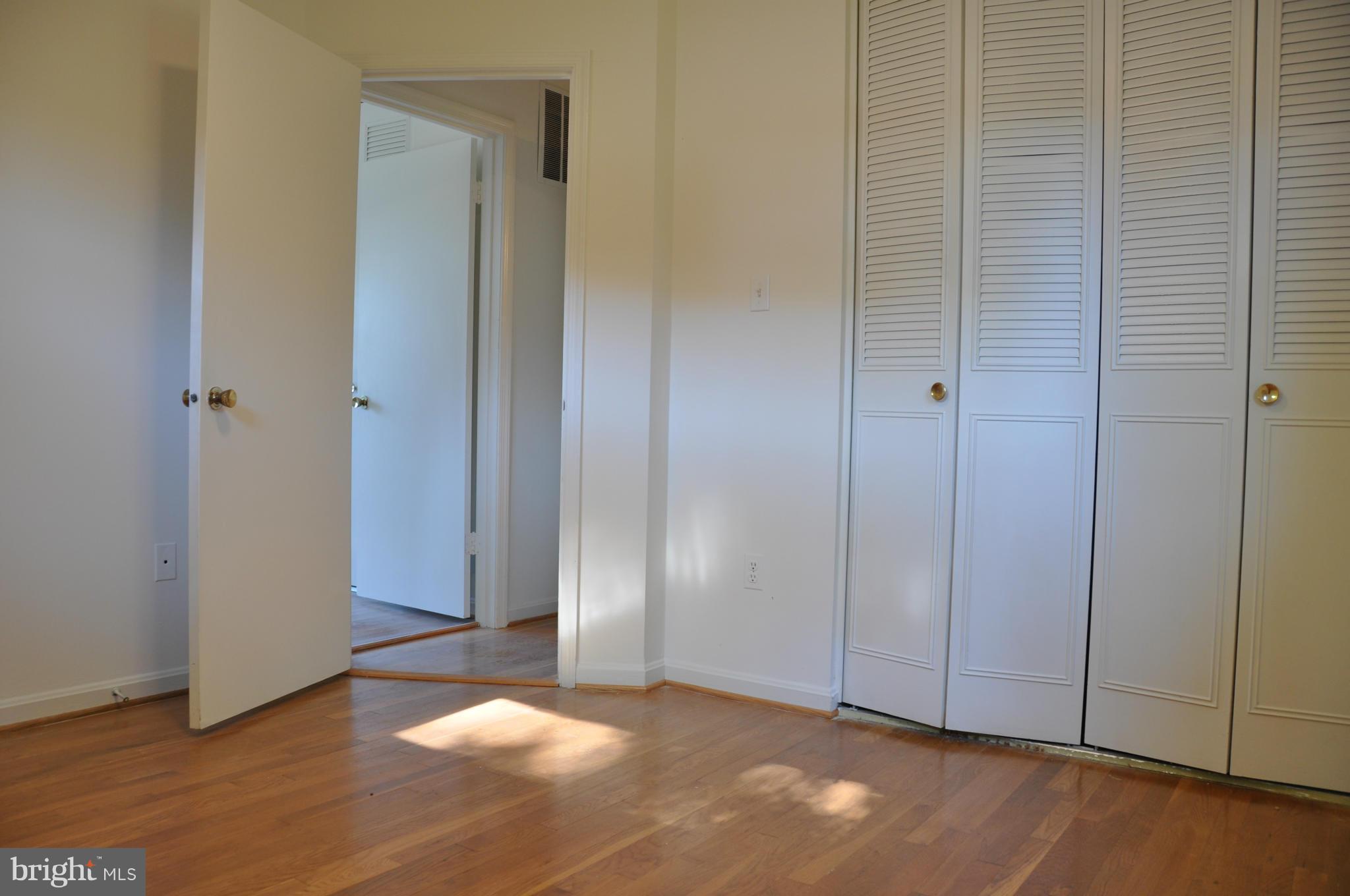 5417 Rolling Road Springfield, VA 22151 - Photo 16 of 20 a view of an empty room and wooden floor