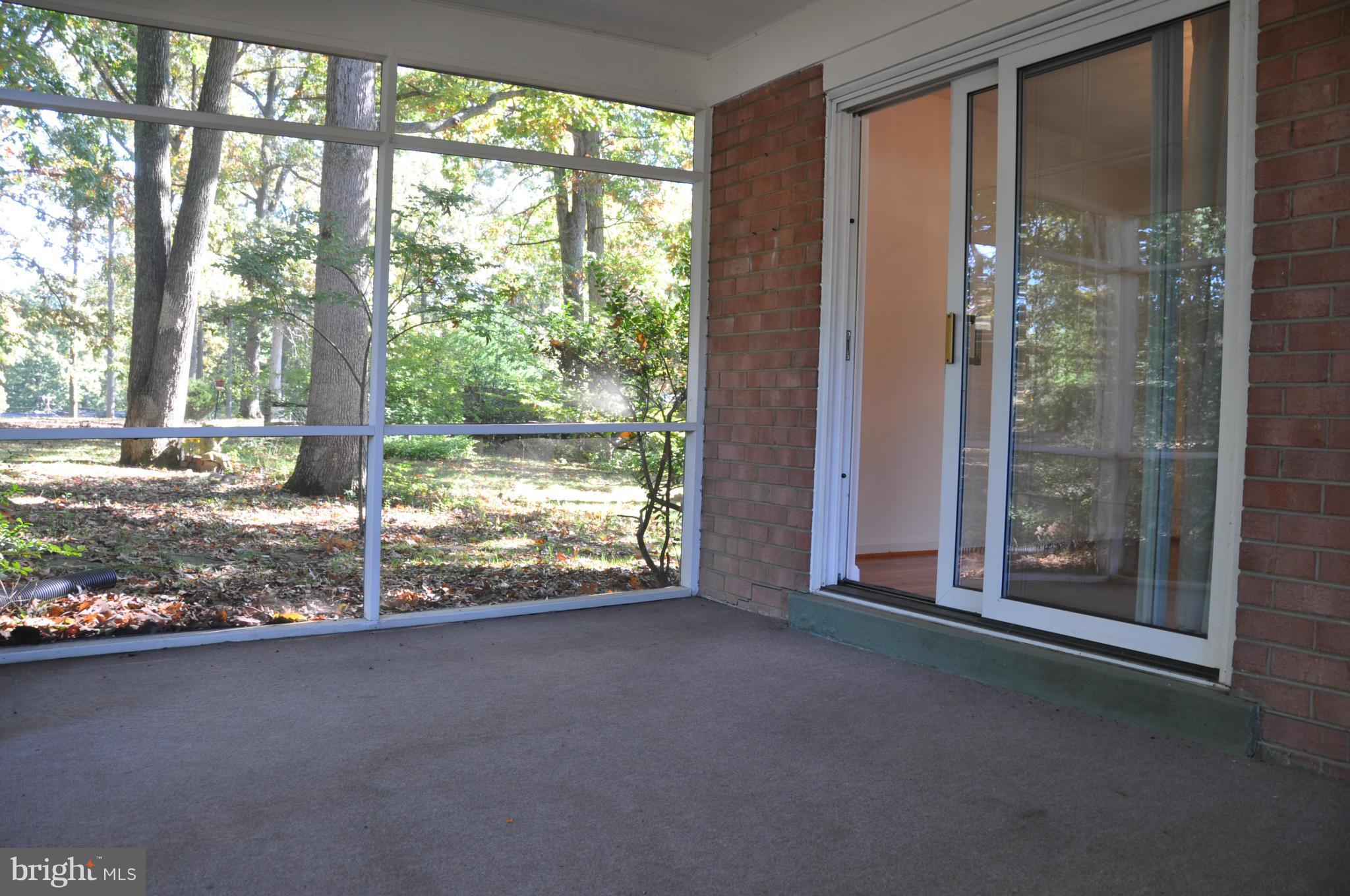 5417 Rolling Road Springfield, VA 22151 - Photo 18 of 20 a view of a room with floor to ceiling windows and an outdoor space