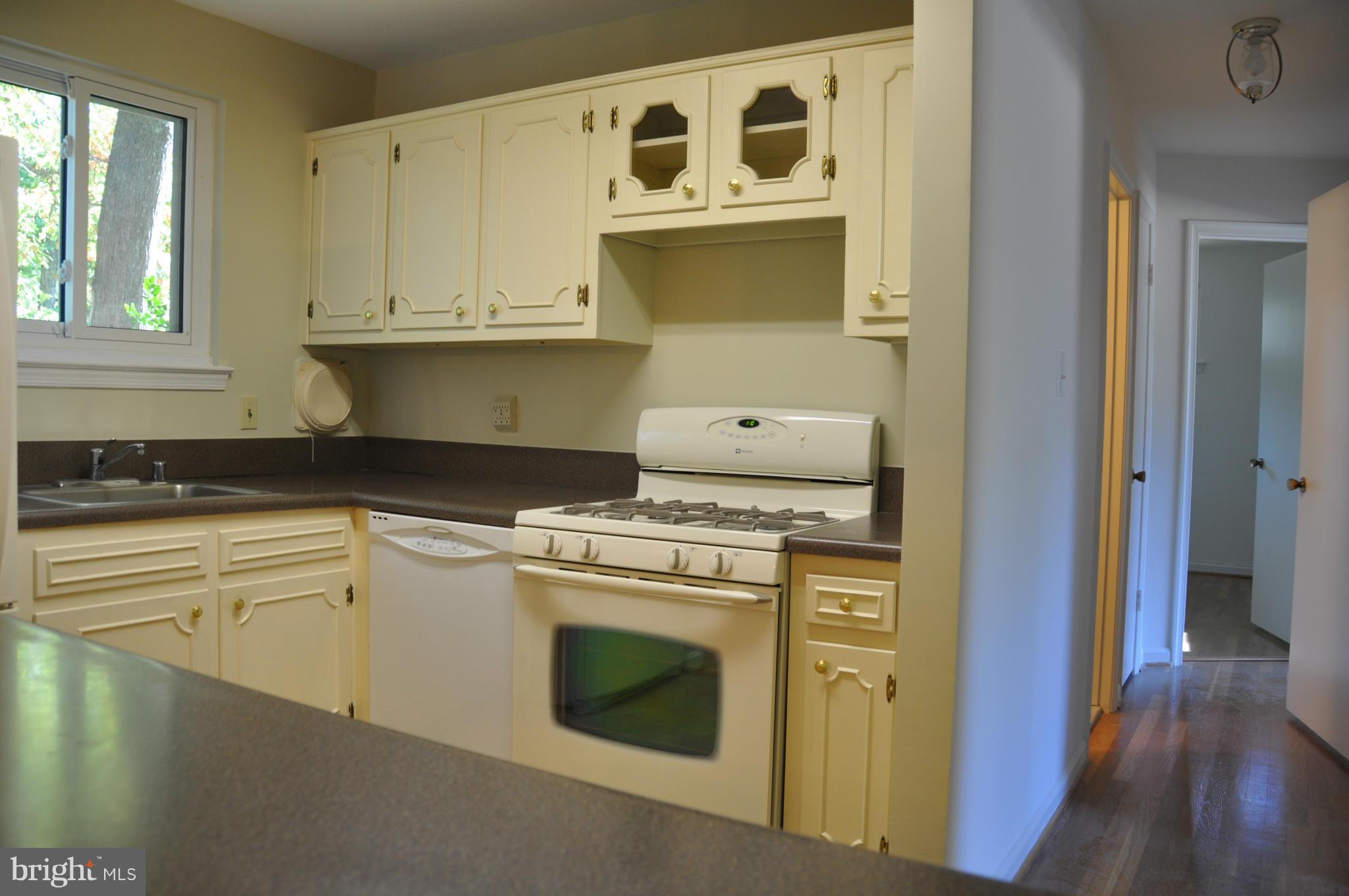 5417 Rolling Road Springfield, VA 22151 - Photo 4 of 20 a kitchen with stainless steel appliances granite countertop a stove and a microwave