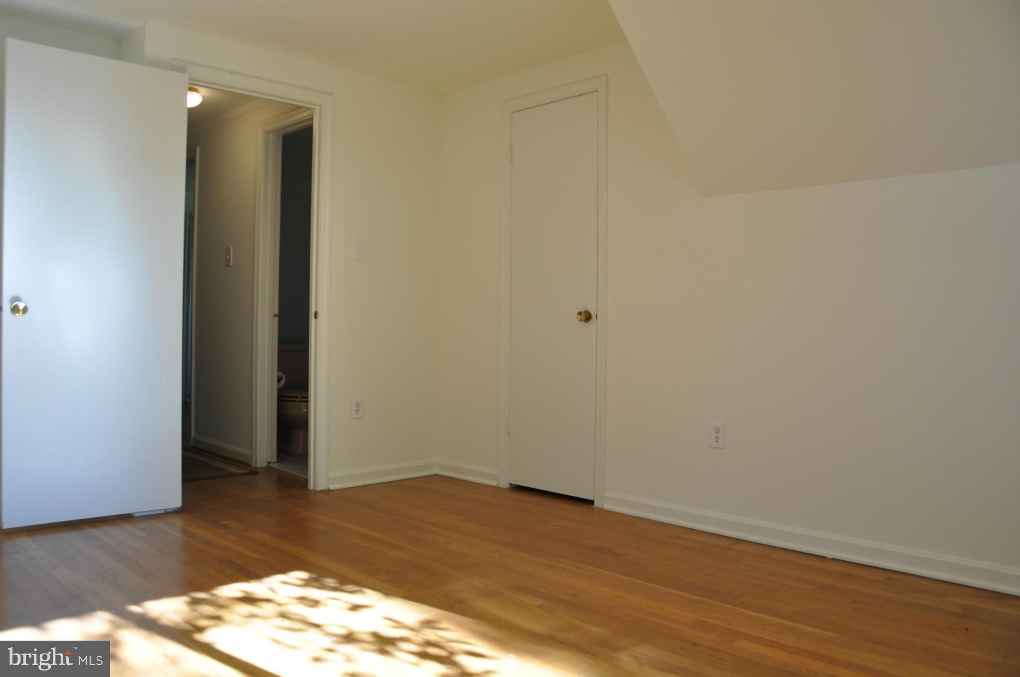 5417 Rolling Road Springfield, VA 22151 - Photo 8 of 20 a view of an empty room and wooden floor