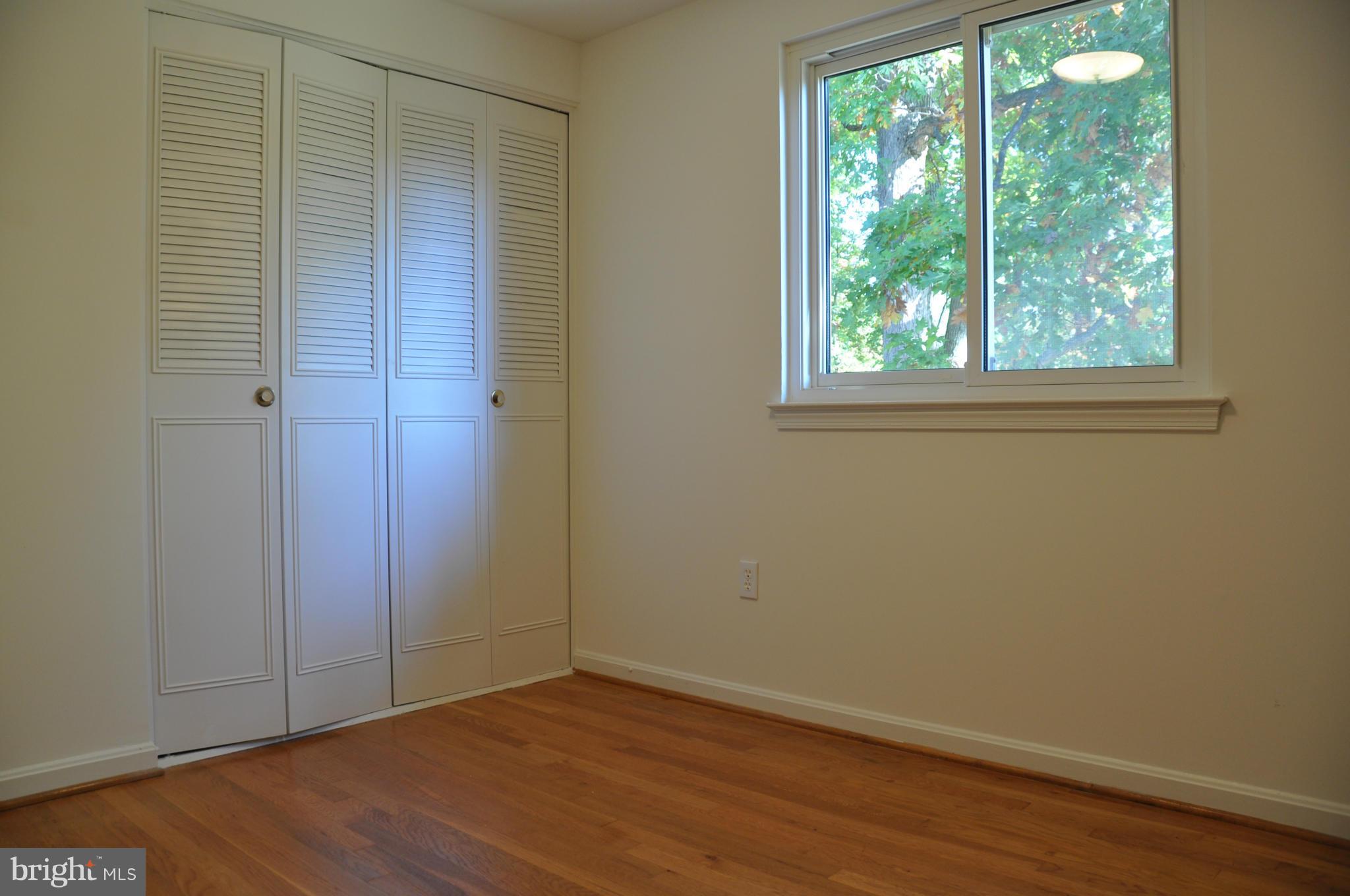 5417 Rolling Road Springfield, VA 22151 - Photo 10 of 20 an empty room with wooden floor and windows