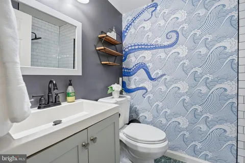 a bathroom with a toilet sink and mirror