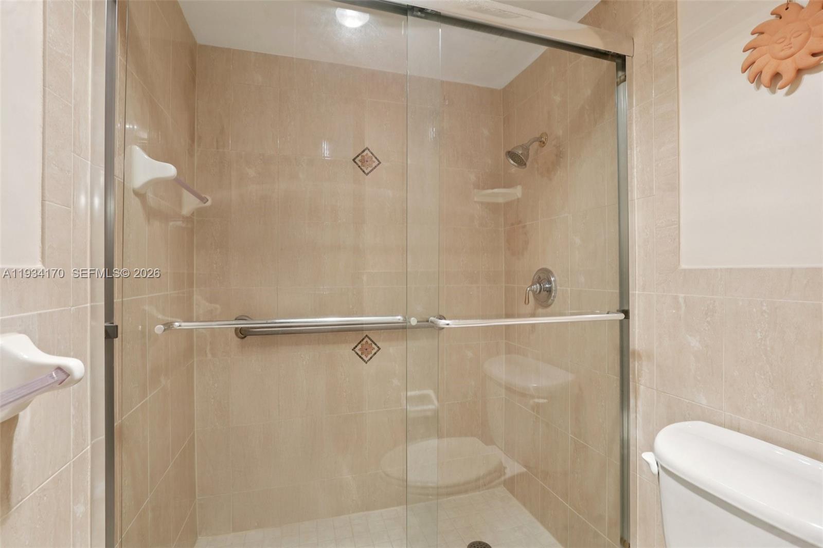 4350 Hillcrest Drive, Unit 702 Hollywood, FL 33021 - Photo 13 of 29 a bathroom with a shower and toilet