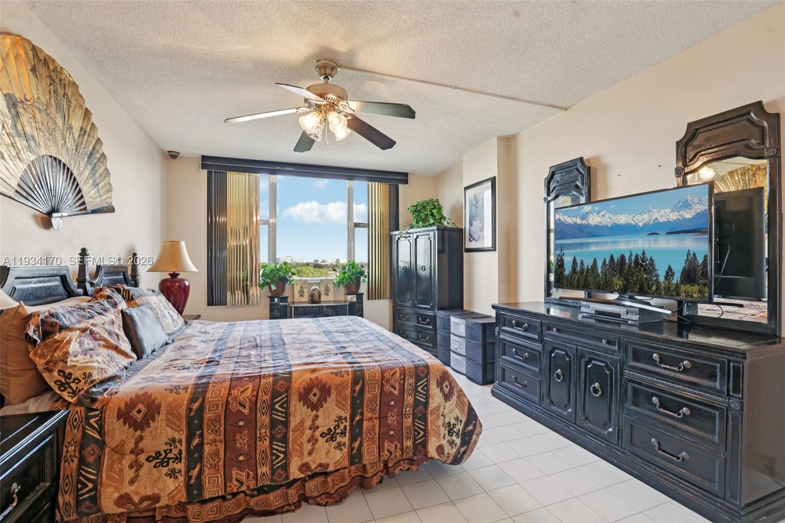 4350 Hillcrest Drive, Unit 702 Hollywood, FL 33021 - Photo 15 of 29 a bedroom with a bed and a flat screen tv