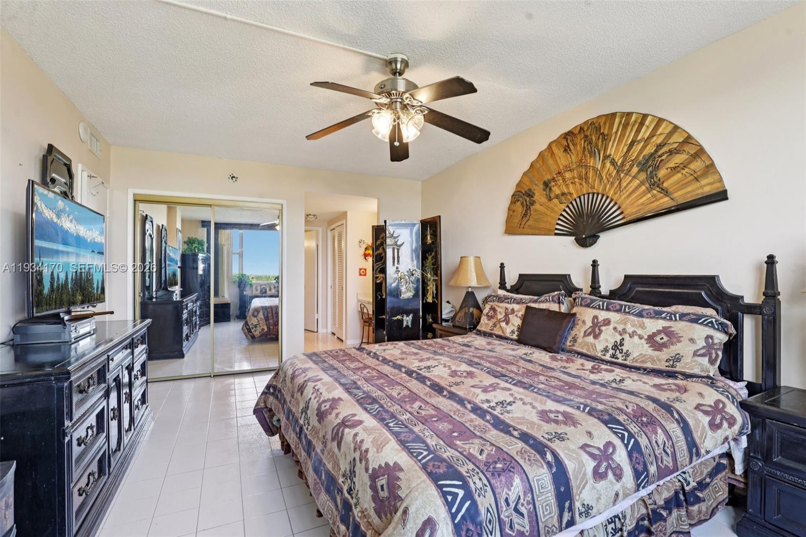 4350 Hillcrest Drive, Unit 702 Hollywood, FL 33021 - Photo 16 of 29 a bedroom with bed and a chandelier