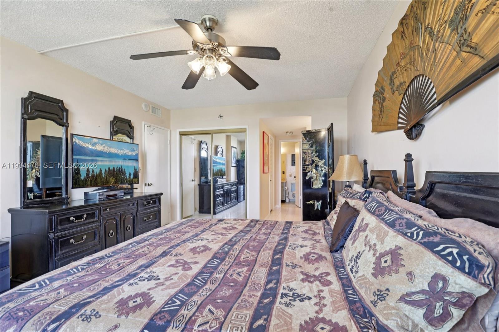 4350 Hillcrest Drive, Unit 702 Hollywood, FL 33021 - Photo 17 of 29 a bedroom with a bed and a flat screen tv