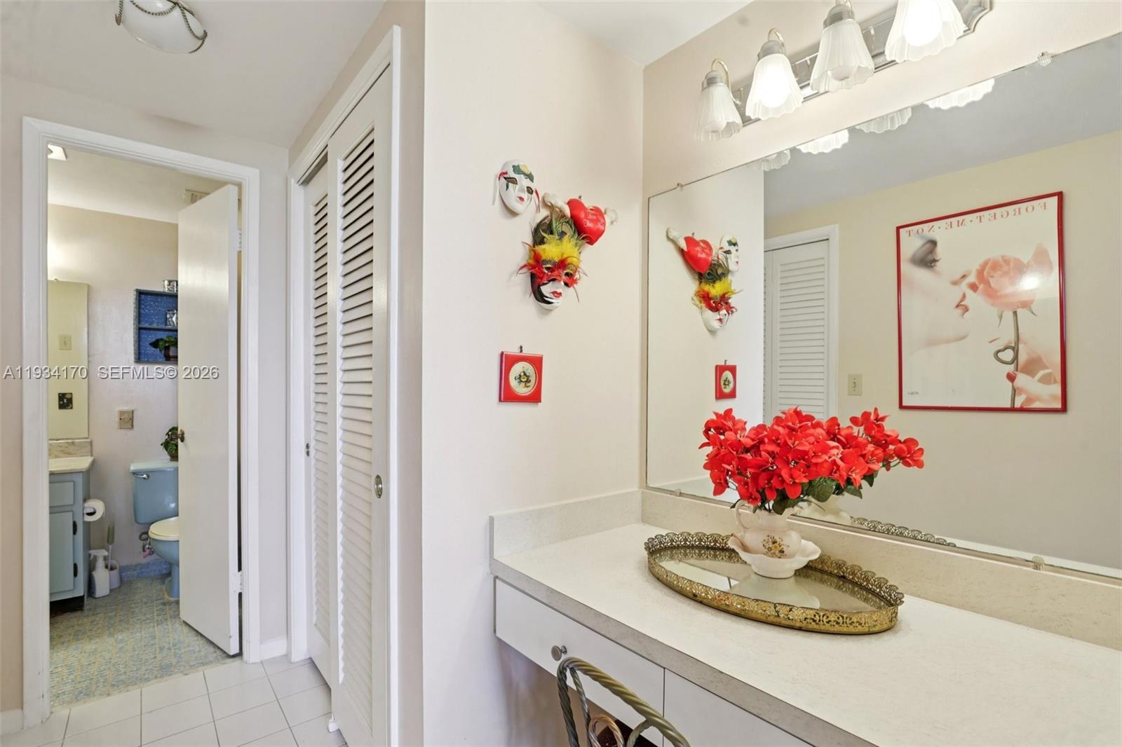 4350 Hillcrest Drive, Unit 702 Hollywood, FL 33021 - Photo 18 of 29 a bathroom with a sink vanity and a mirror