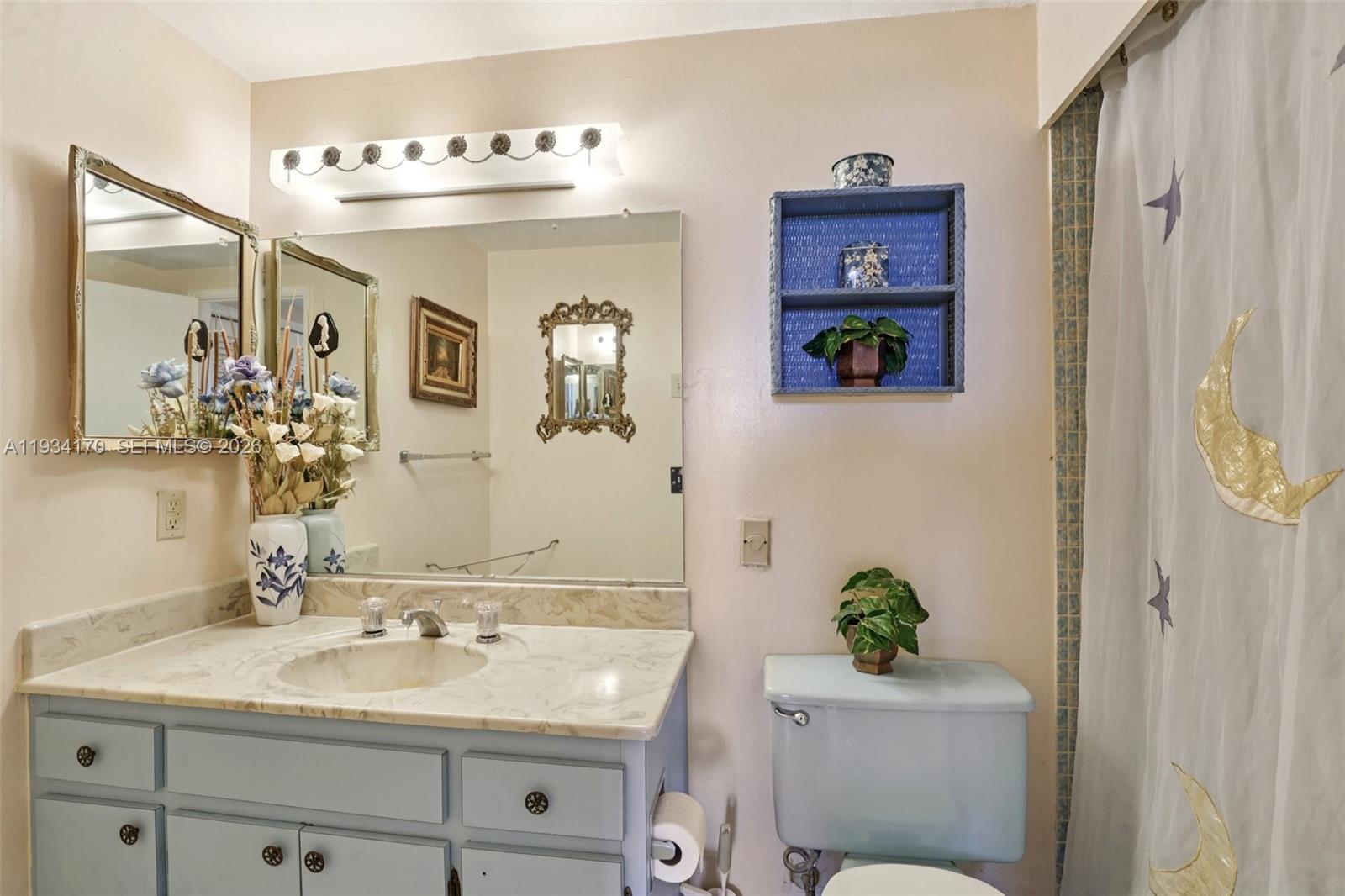 4350 Hillcrest Drive, Unit 702 Hollywood, FL 33021 - Photo 19 of 29 a bathroom with a sink a toilet and mirror