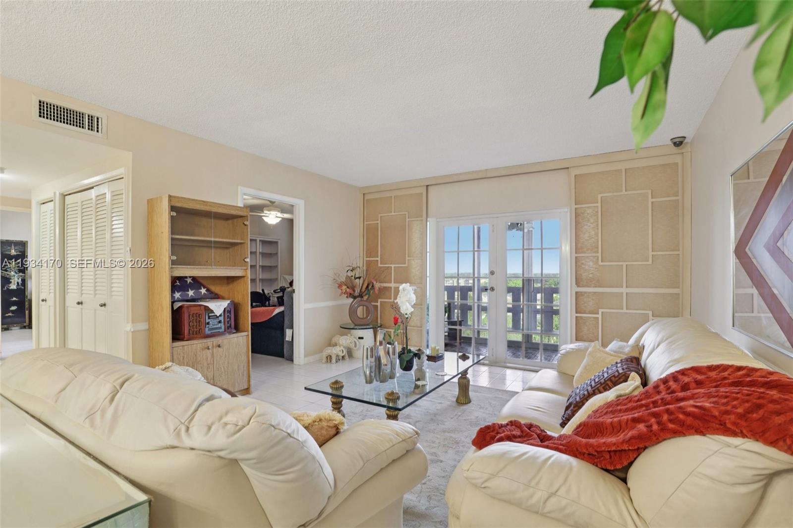 4350 Hillcrest Drive, Unit 702 Hollywood, FL 33021 - Photo 2 of 29 a living room with furniture and a large window