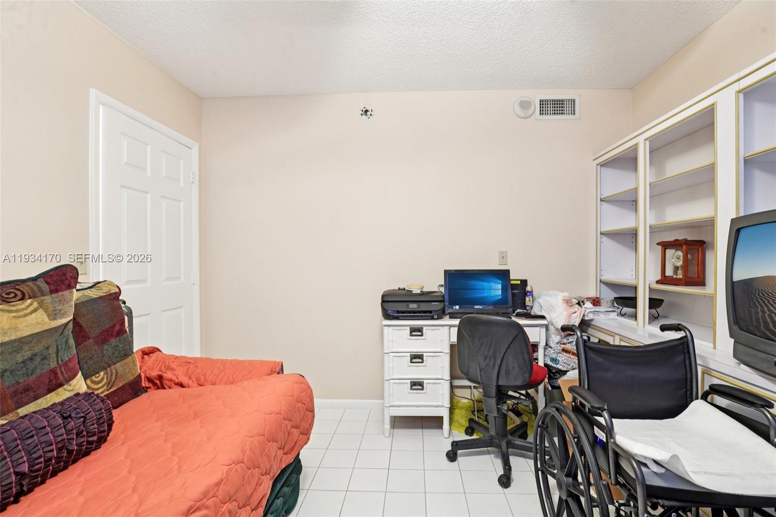 4350 Hillcrest Drive, Unit 702 Hollywood, FL 33021 - Photo 25 of 29 a bedroom with a bed and a chandelier