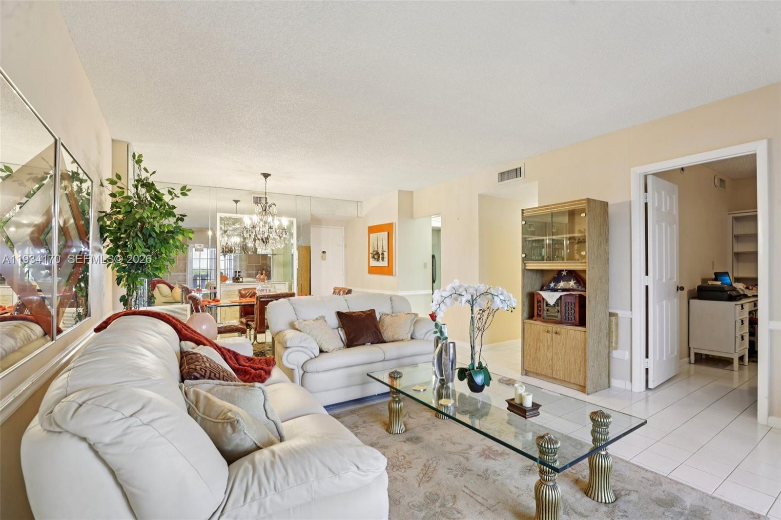 4350 Hillcrest Drive, Unit 702 Hollywood, FL 33021 - Photo 3 of 29 a living room with furniture a lamp and a large window