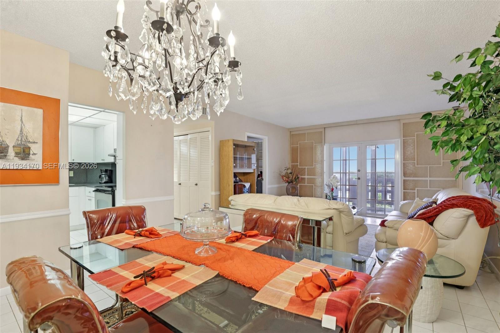 4350 Hillcrest Drive, Unit 702 Hollywood, FL 33021 - Photo 7 of 29 a living room with furniture a chandelier and a fireplace