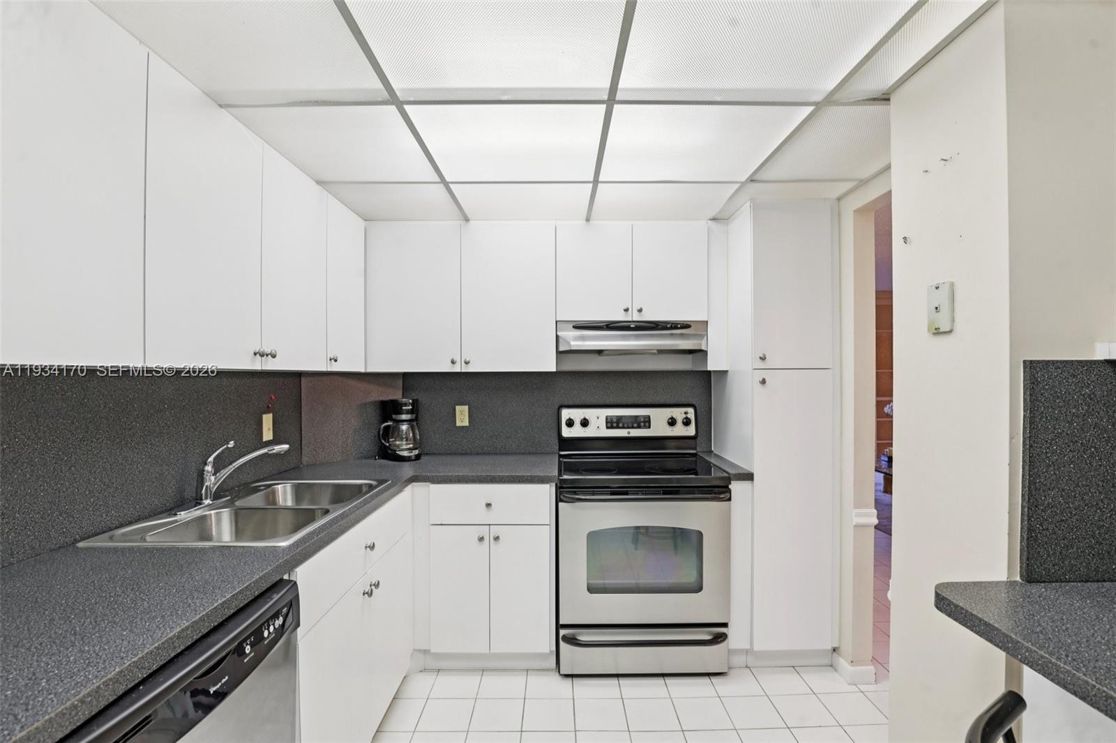 4350 Hillcrest Drive, Unit 702 Hollywood, FL 33021 - Photo 8 of 29 a kitchen with a sink a stove and cabinets