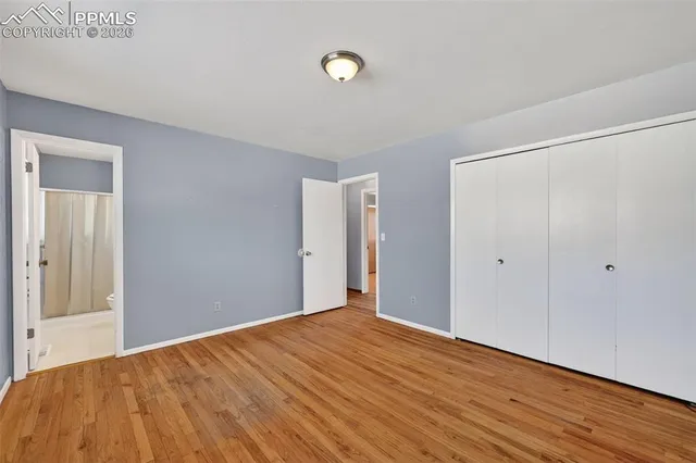 a view of empty room with wooden floor