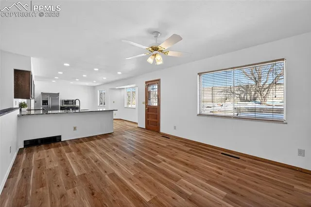 a view of kitchen with cabinets and wooden floor