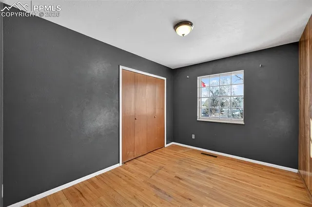 a view of a room with wooden floor and windows