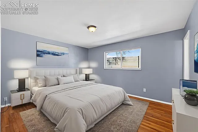 a bedroom with a bed and a painting on the wall