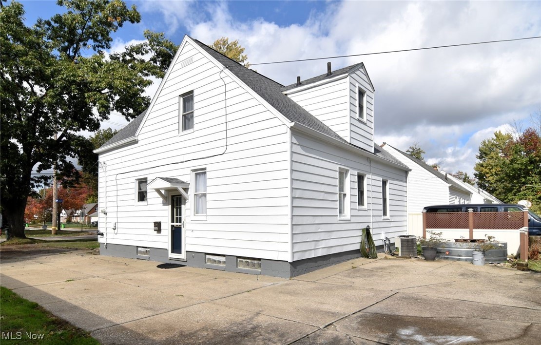 1575 Lander Road Cleveland, OH 44124 - Photo 43 of 49 View of property exterior featuring a shingled roof and a central AC unit