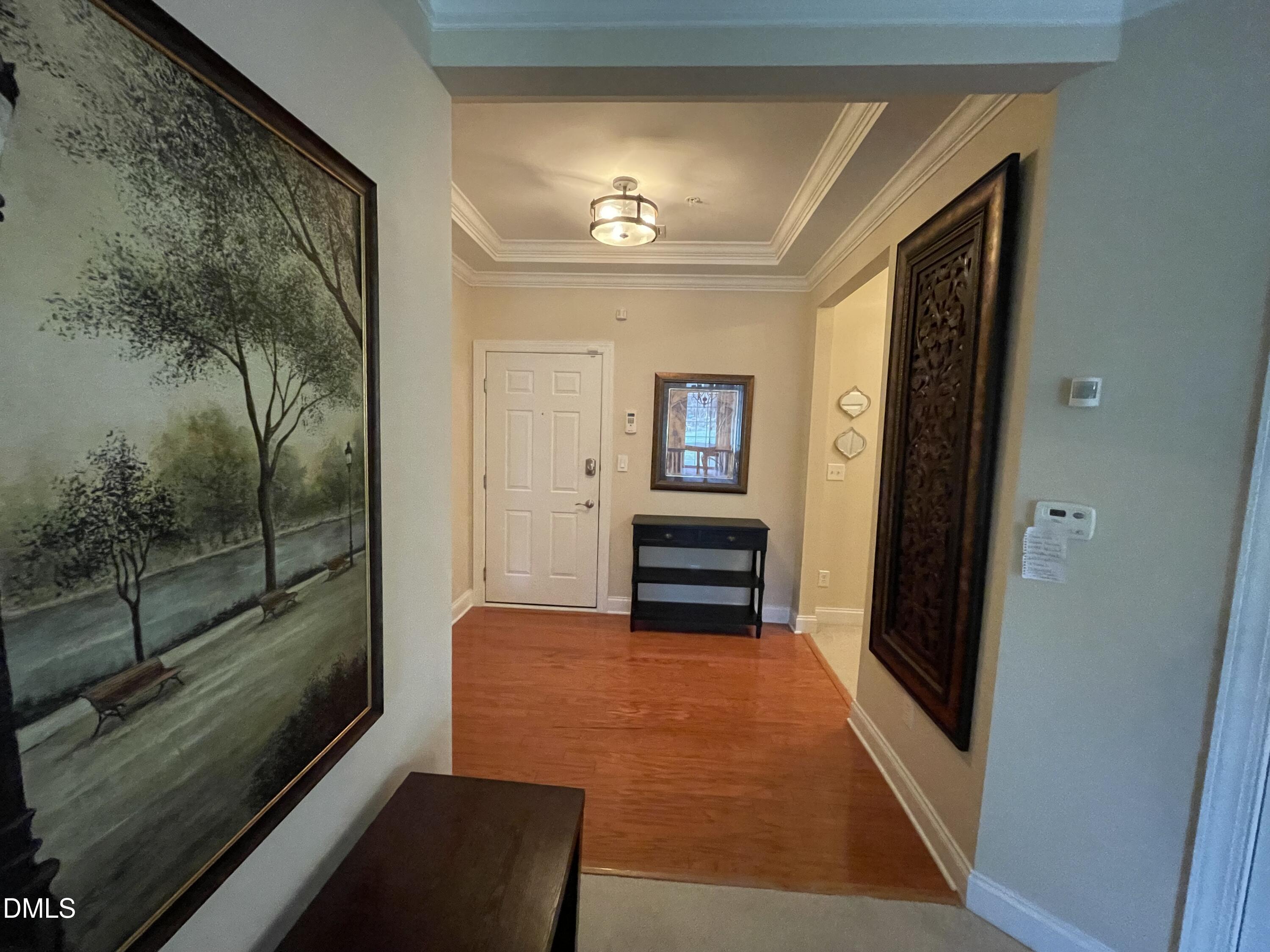 10411 Rosegate Court, Unit 3 Raleigh, NC 27617 - Photo 35 of 62 a view of a hallway with wooden floor and glass door