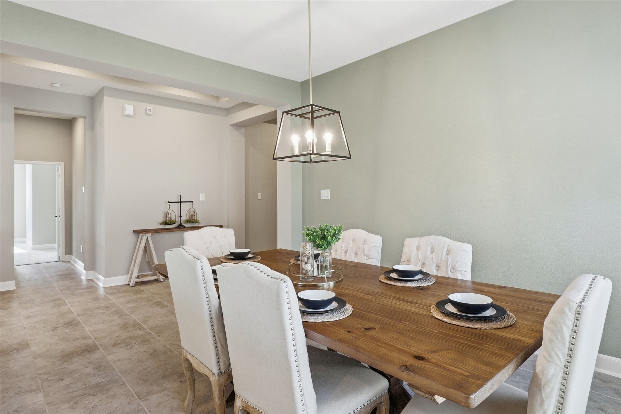 24126 Cane Fields Road Katy, TX 77493 - Photo 6 of 36 Elegant dining room highlighted by updated designer lighting, perfect for family gatherings and entertaining.