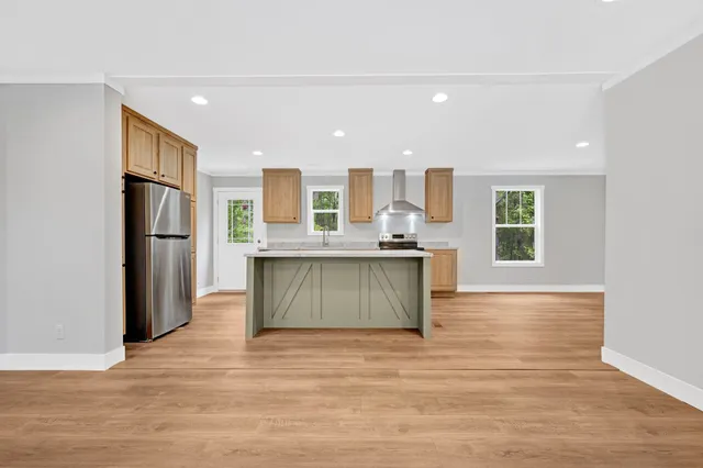 a kitchen with stainless steel appliances granite countertop a refrigerator sink and stove