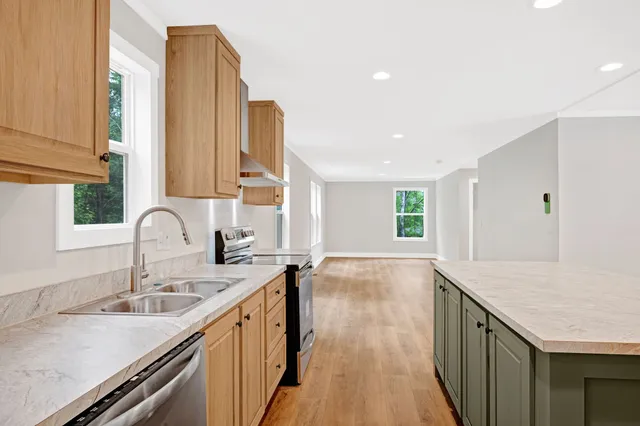 a kitchen with a sink stove and cabinets