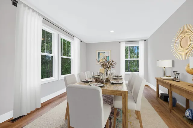 a dining room with furniture and window
