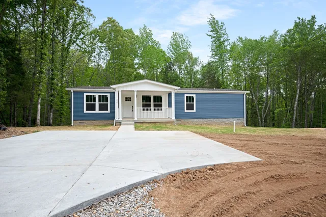 a view of a house with pool and a yard