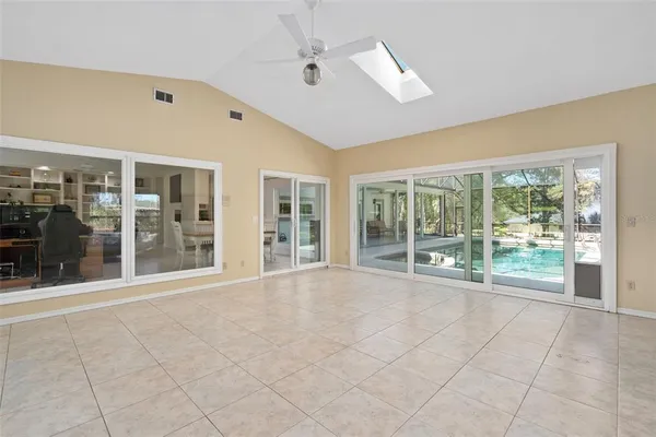 a view of an empty room with a floor to ceiling window and an outdoor space