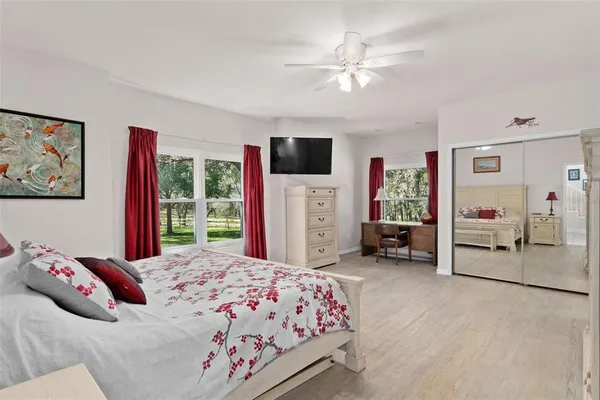a bedroom with a bed and a large window