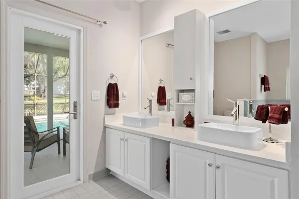 a bathroom with a double vanity sink mirror and