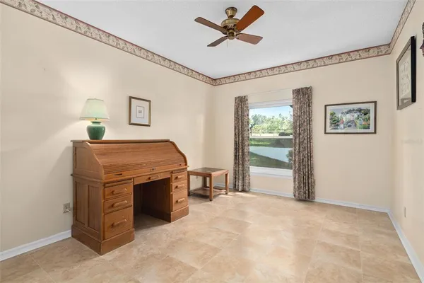 a view of a livingroom with furniture and ceiling fan
