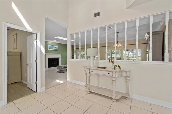 a dining room with furniture and large windows