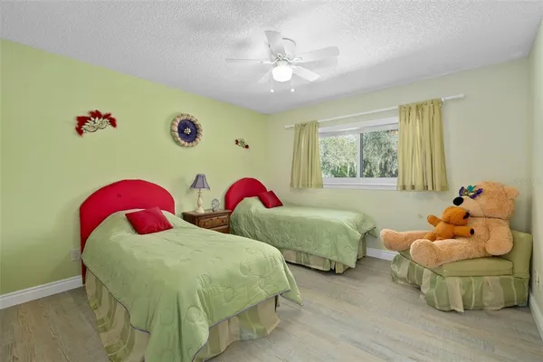 a bedroom with two beds and a chandelier