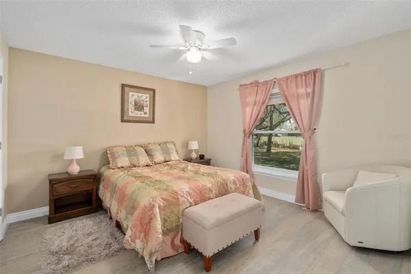 a spacious bedroom with a bed and a large window