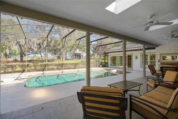 a front view of a house with swimming pool and sitting area