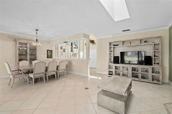 a room with stainless steel appliances lots of white furniture a window and a kitchen view
