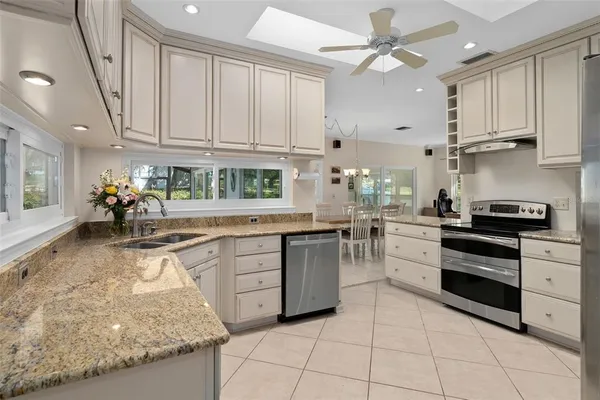 a kitchen with stainless steel appliances granite countertop a sink and cabinets