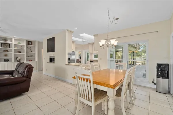a view of a dining room with furniture and chandelier