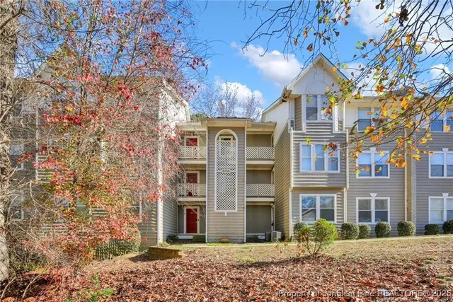 a front view of a building with a yard