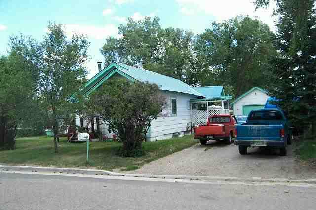 849 Russell Street Craig, CO 81625 - Photo 2 of 2 a front view of a house with a garden and parking