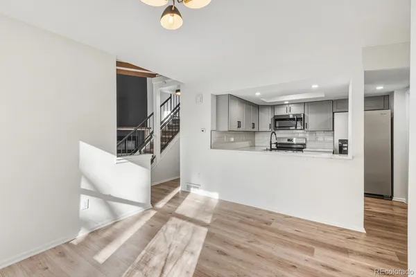 a view of kitchen with furniture and wooden floor