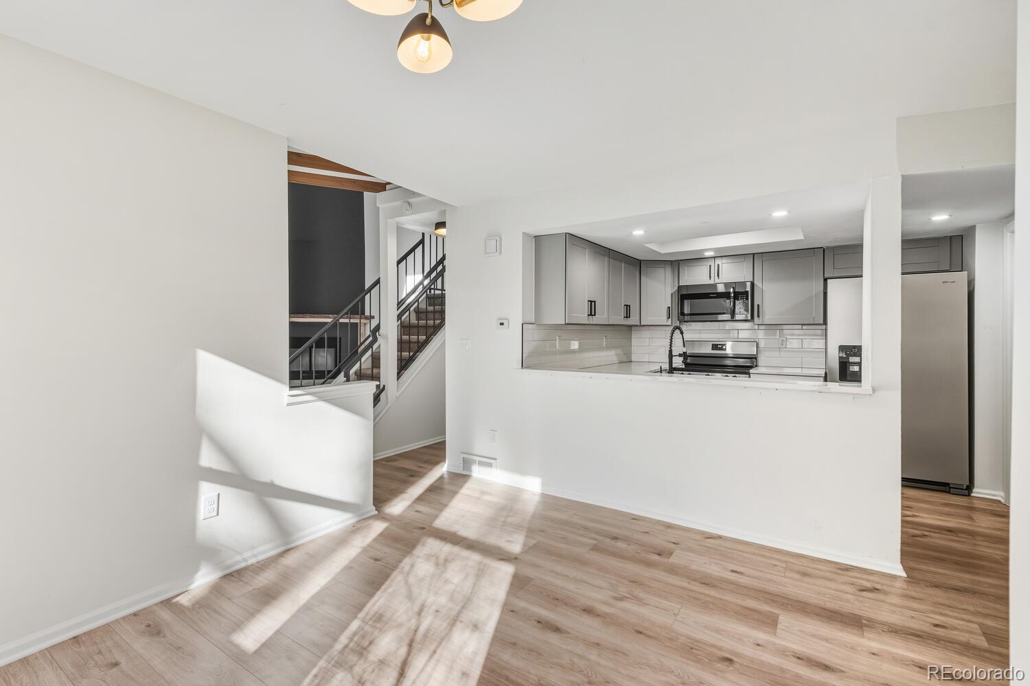9041 Zephyr Court Broomfield, CO 80021 - Photo 11 of 35 a view of kitchen with furniture and wooden floor