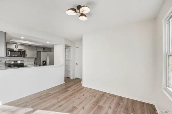 a view of a kitchen with a sink and refrigerator