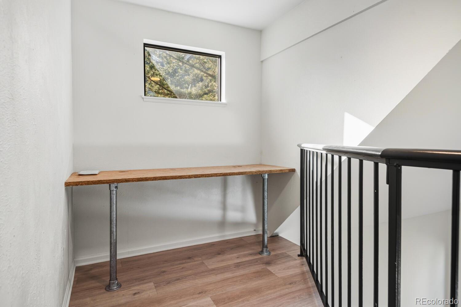 9041 Zephyr Court Broomfield, CO 80021 - Photo 23 of 35 a view of a hallway with wooden floor