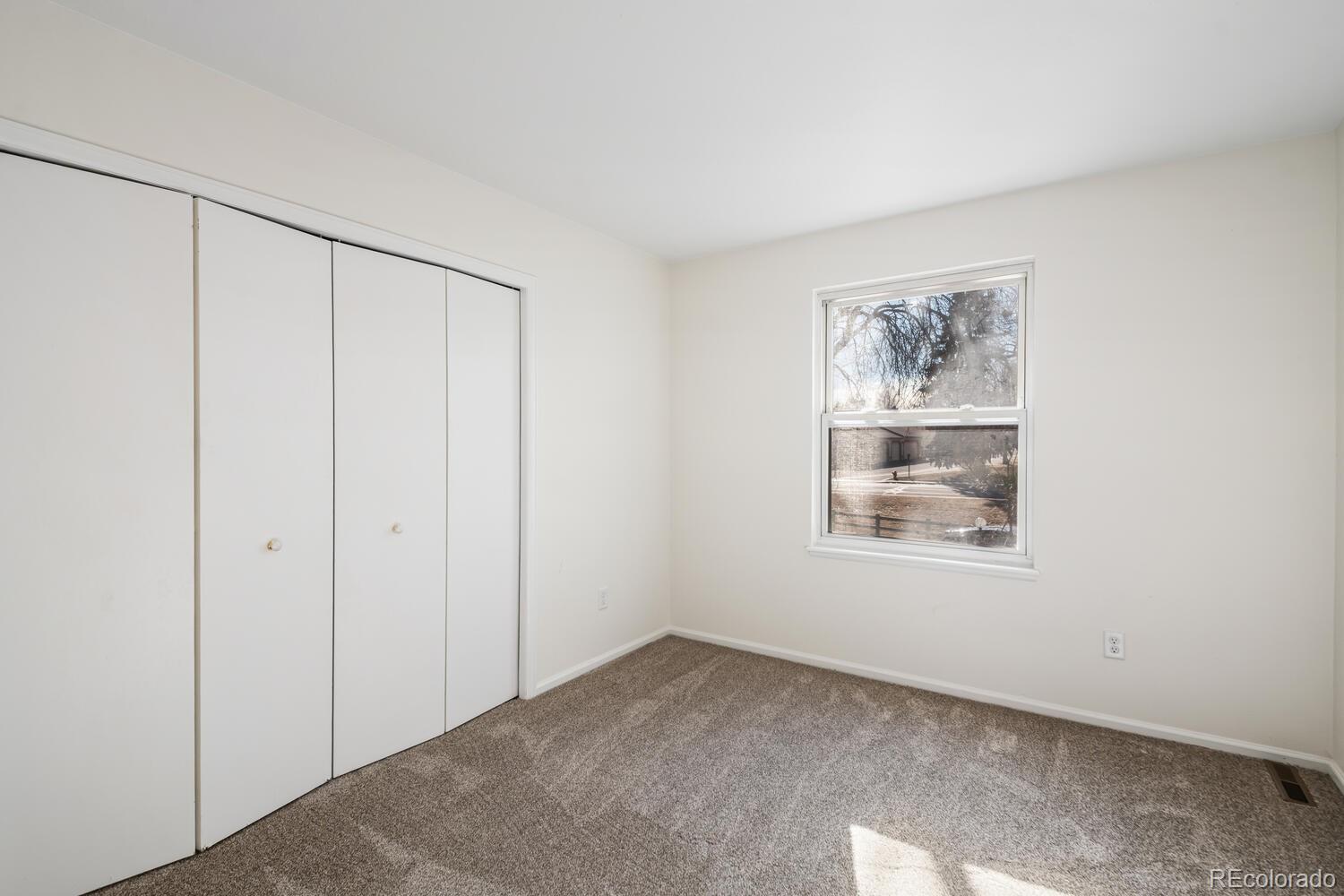 9041 Zephyr Court Broomfield, CO 80021 - Photo 24 of 35 a view of an empty room with a window
