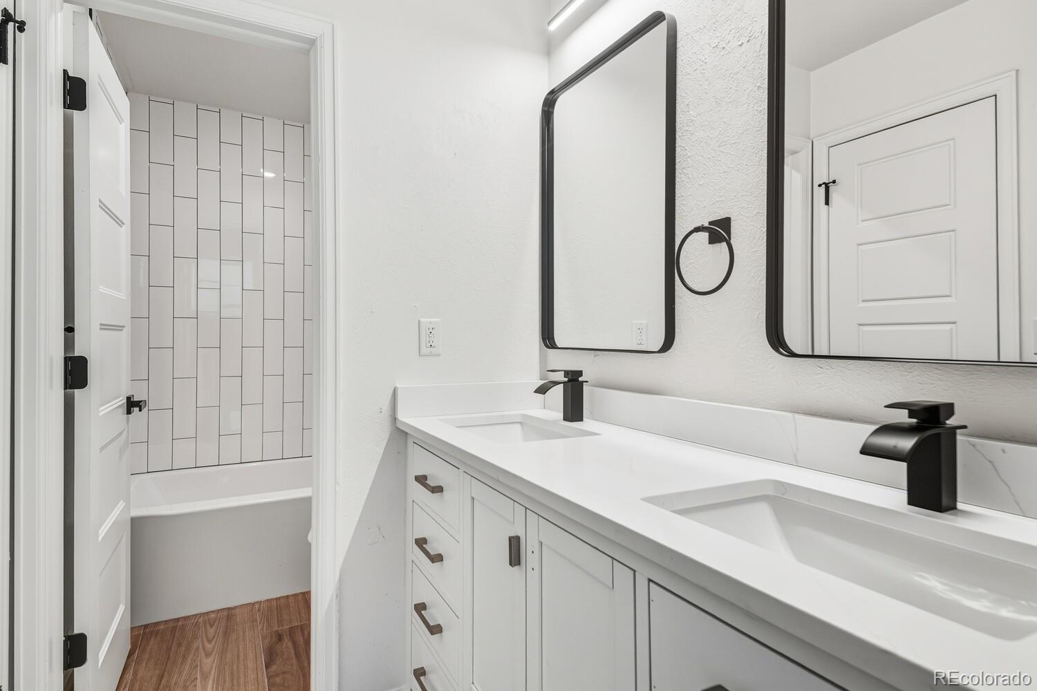 9041 Zephyr Court Broomfield, CO 80021 - Photo 26 of 35 a bathroom with a sink and a mirror